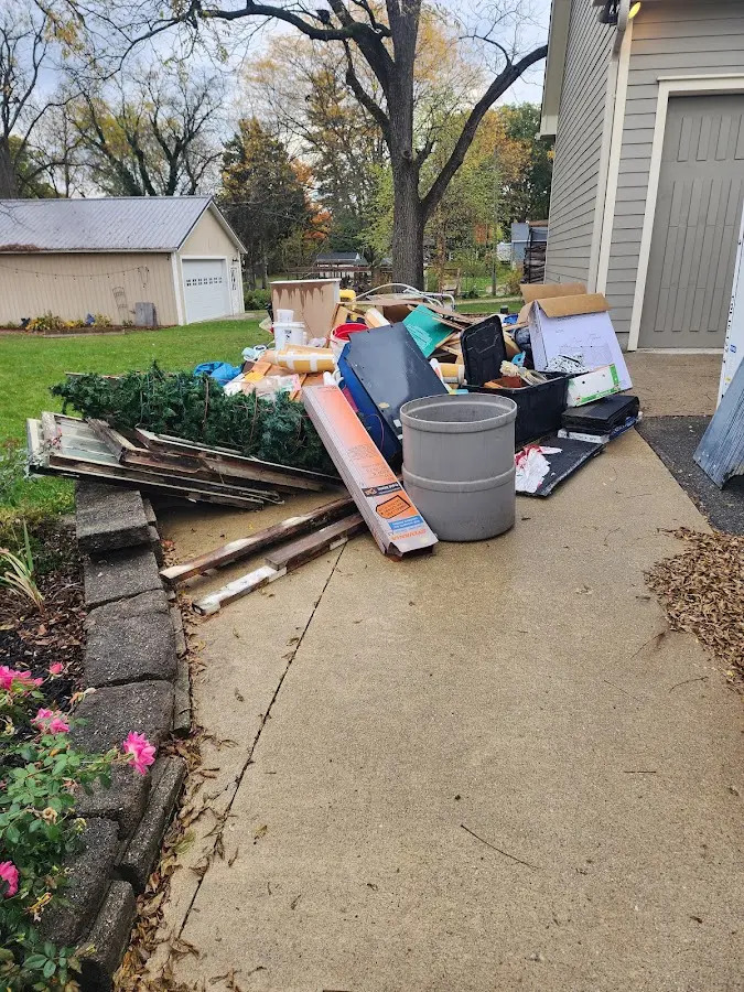 Dumpster being loaded with debris for 12 Yard Dumpster Rental in Derry